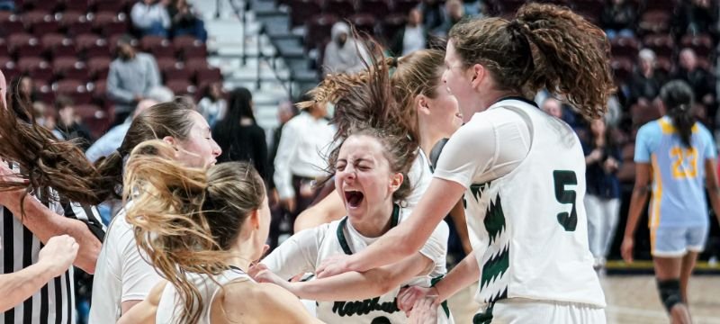 girls basketball team celebrating championship win